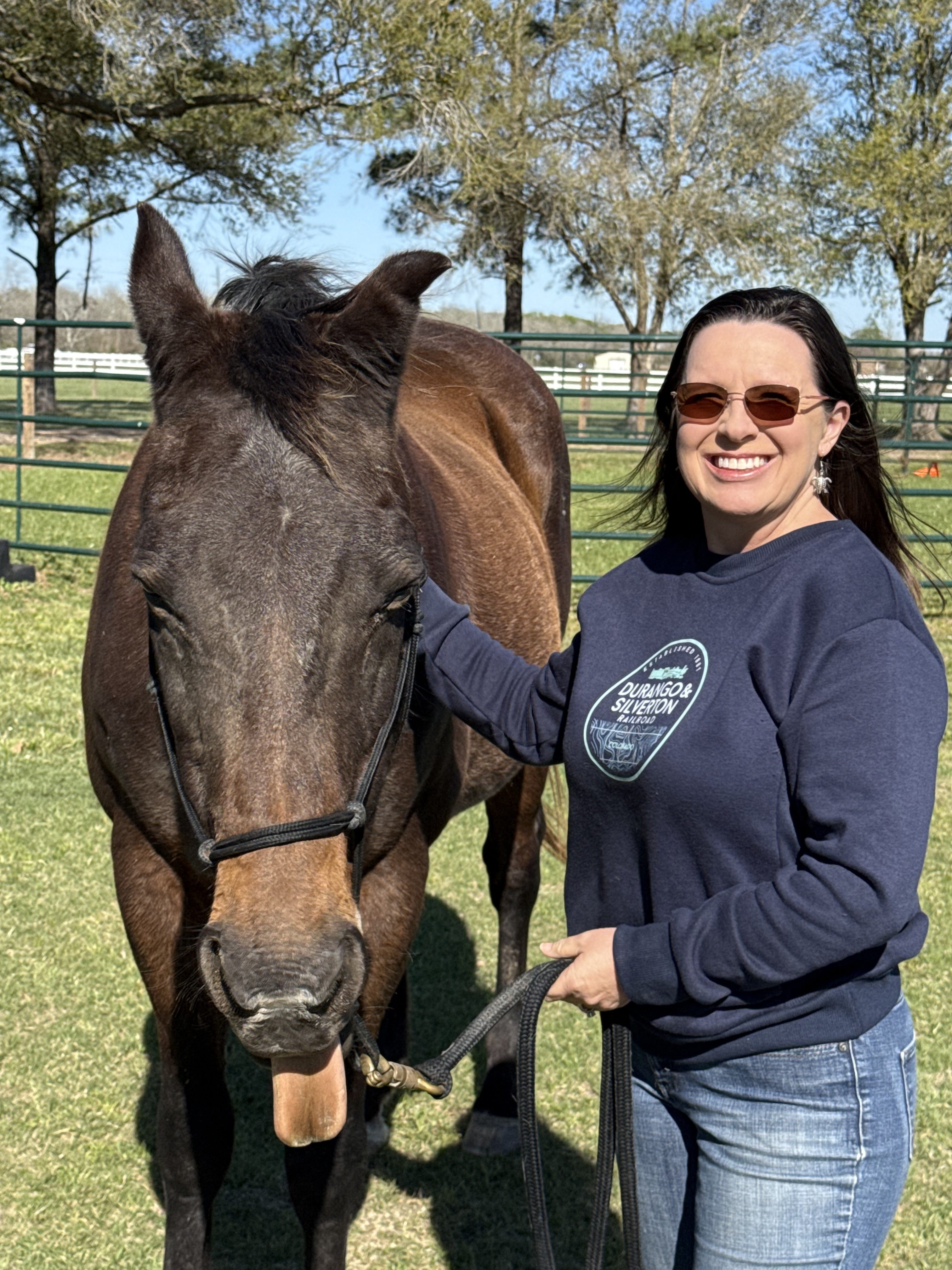 Janet with a horse sticking it's tongue out